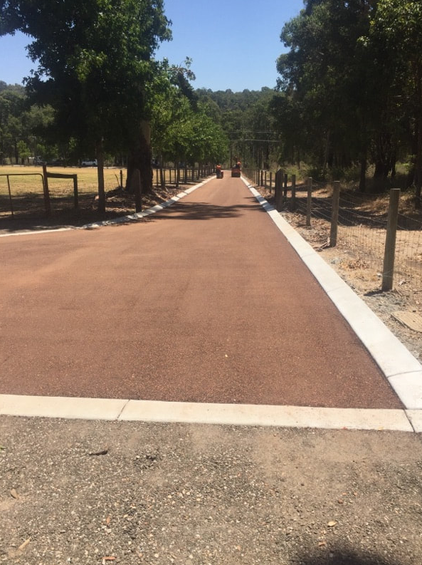 This is a photo of a hot spray & seal bitumen roadway which is in the process of being installed by Albury Road Tech
